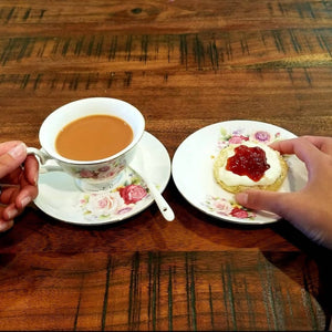 drinking tea with Britalicious scone and clotted cream and jam